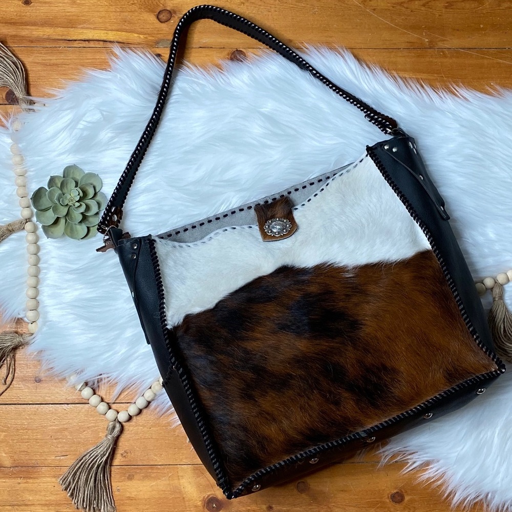 Cowhide and leather hand tooled shoulder bag